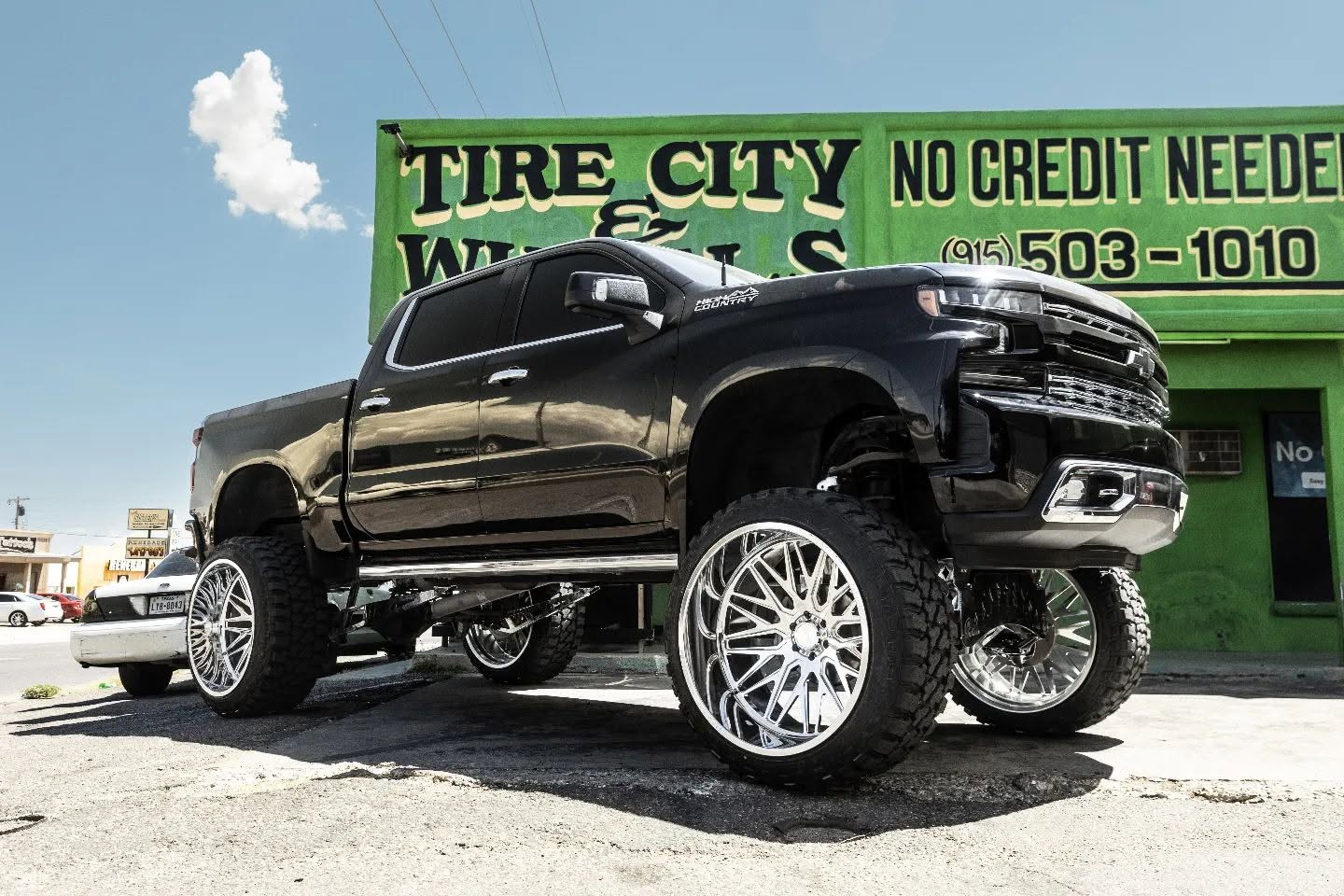 Lifted Silverado on 28 inch chrome wheels at Tire City
